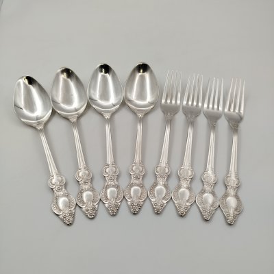 купить Набор столовых приборов на 4 персоны, украшенных растительным декором (4 ложки и 4 вилки), мНЦ (медь-никель-цинк), Режевский механический завод (РМ), СССР, 1983-1991 гг.