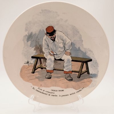 купить Тарелка декоративная "Cruelle Enigme. Ecole de compagnie. Au commandement de marche, la premiere section s'arrete!?" ("Жестокая загадка. Школа роты. По команде к маршу первый отряд останавливается!?"), с подписью автора рисунка, фаянс, деколь, Sarreguemines (Саргемин), Франция, 1890-1920 гг.